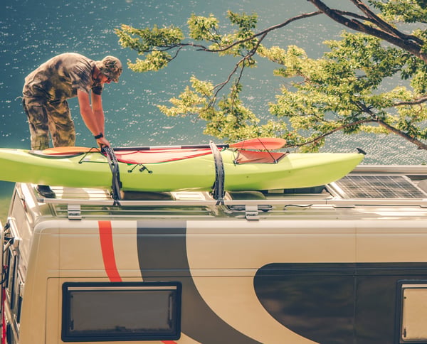 man installing a kayak on the roof af an RV to represent how to and tips for all things related to RVing
